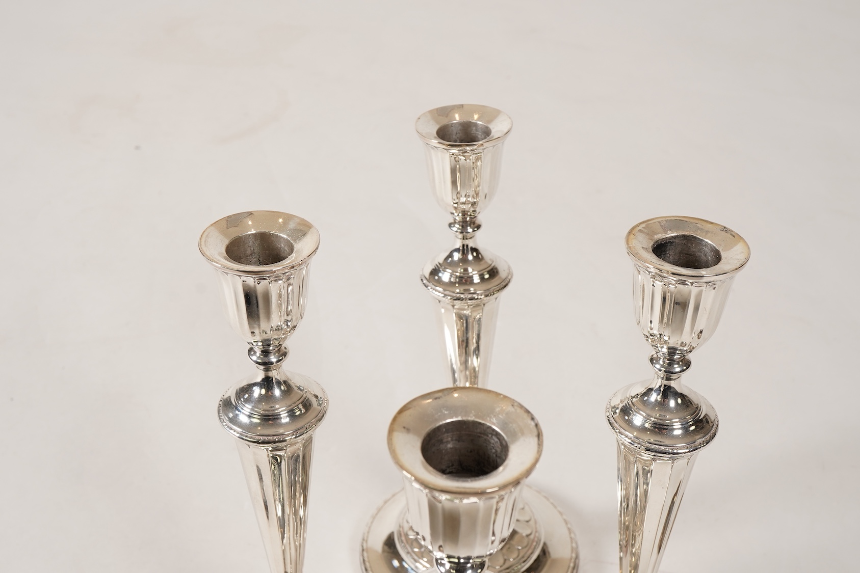 A set of four George III silver candlesticks, by John Green, Roberts, Mosley & Co